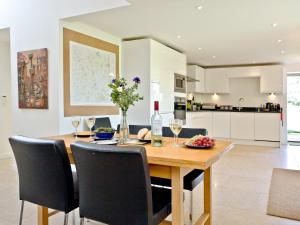 a kitchen and dining room with a wooden table and chairs at Antells Farm Barn in Sturminster Newton