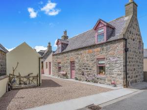 a stone house with bikes parked outside of it at Coast Away in Fraserburgh