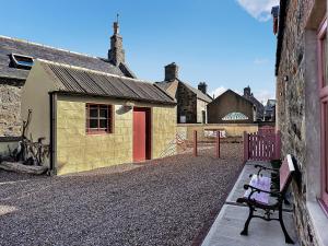 a bench sitting in front of a building at Coast Away in Fraserburgh +33 photos