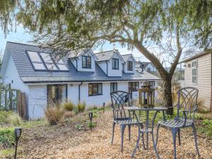 a table and chairs in front of a house at Amaranth in Shurdington
