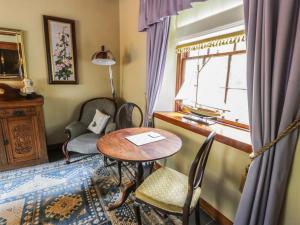 a room with a table and chairs and a window at Duck Pond- Uk7232 in Kirkmichael