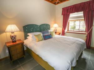 a bedroom with a large bed and a window at Duck Pond- Uk7232 in Kirkmichael +21 photos