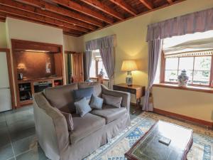 a living room with a couch and a window at Duck Pond- Uk7232 in Kirkmichael