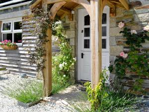 an entrance to a stone house with a wooden door at Blackberry Cottage in North Hill