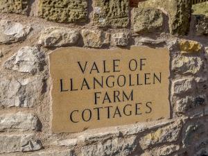 a sign on the side of a stone wall at Y Stabl - Uk12742 in Acrefair +21 photos