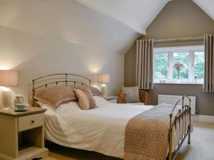 a bedroom with a large bed and a window at The Coach House in Keswick
