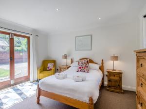 a bedroom with a large white bed and a window at Beech Barns - Czu in Neatishead