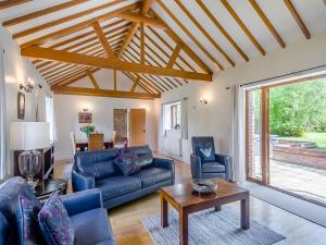 a living room with a couch and a table at Beech Barns - Czu in Neatishead