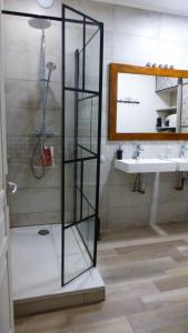 a glass shelf in a bathroom with a sink at Le logis de Presle in Avallon +10 photos