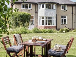 a wooden table in the yard of a house at Green Acres in Llangollen