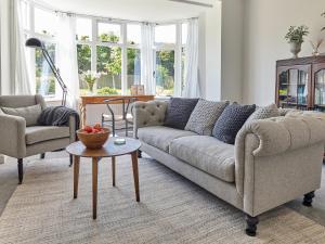 a living room with a couch and a table at Green Acres in Llangollen