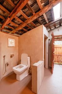 a bathroom with a toilet and a sink at The Attic Library by AVVAs Stays in Bīr