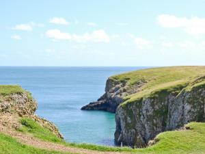 a view of the ocean from a cliff at The Stable - Om4 in Mydroilin