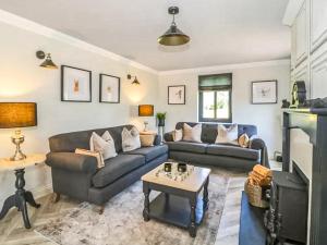 a living room with a couch and a table at Garth End in Appleby