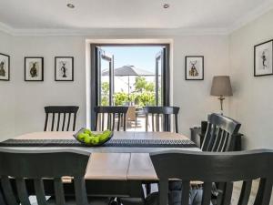 a dining room table with a bowl of fruit on it at Garth End in Appleby