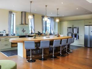 a kitchen with a large wooden table and chairs at Snowdon Summit View in Llanllyfni +22 photos