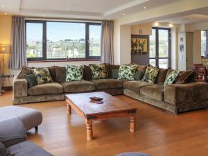 a living room with a couch and a coffee table at Snowdon Summit View in Llanllyfni