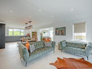 a living room with two couches and a table at Hillside House in Berwick-Upon-Tweed