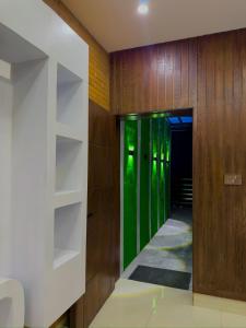 a hallway with wooden walls and green glass panels at Go Glam Hotels Murree in Murree