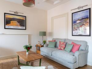 a living room with a couch and a table at Tree House - Uk7556 in Inverness