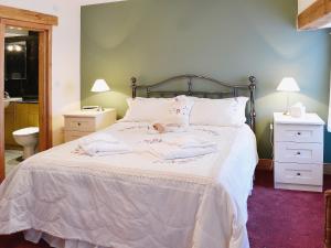 a bed with two towels and a teddy bear on it at Bram Crag Barn in Legburthwaite