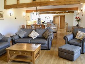 a living room with couches and a coffee table at Bram Crag Barn in Legburthwaite