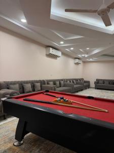 a pool table in a conference room with chairs and a pool at Rovana Chalet in Barka
