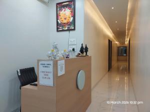 a hospital hallway with a sign on the wall at Vishal Lodge in Yermala