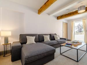 a living room with a couch and a table at The Hayloft - Uk34565 in Whitchurch