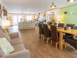 a dining room and living room with a table and chairs at Sycamore Cottage-Uk2785 in Penmaen-mawr
