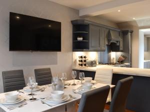 a dining room table with chairs and wine glasses at Apple Tree House in Dalry