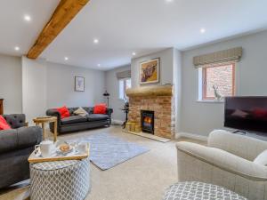a living room with a couch and a fireplace at The Vintage Store - Uk32652 in Elston