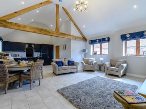 a living room with a table and chairs at The Wheat Store - Uk32649 in Elston