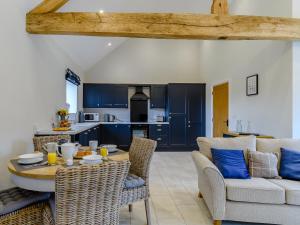 a kitchen and living room with a table and chairs at The Wheat Store - Uk32649 in Elston