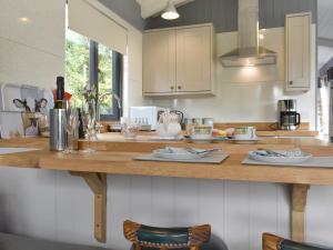 a kitchen with a wooden counter top with dishes on it at Ponsford Ponds Jacks Shepherd Hut - Bcponhut in Cullompton