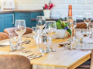 a wooden table with wine glasses on it at The Old Stables - Uk37000 in Ridlington