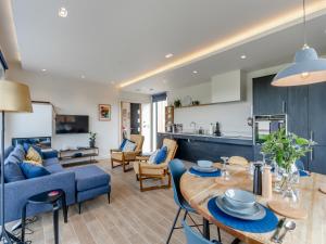 a living room with a blue couch and a table at Buttercup Lodge - Uk36655 in Boothby Pagnell +22 photos