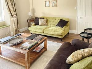a living room with a couch and a coffee table at Honey Cottage in Gargrave