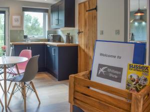 a welcome sign in a kitchen with a table at Willows View in Etchingham