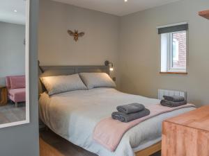 a bedroom with a bed with two towels on it at Willows View in Etchingham