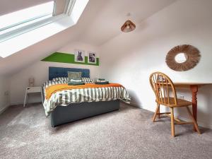 a bedroom with a bed and a desk and a chair at No 3 Rabbit Warren-Uk44299 in Lenwade +10 photos