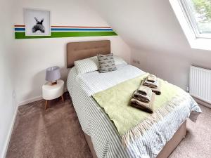 a bedroom with a bed with towels on it at No 3 Rabbit Warren-Uk44299 in Lenwade
