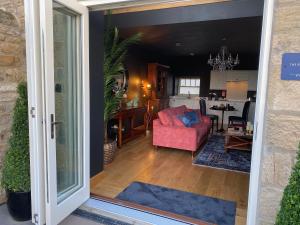 an open door to a living room with a pink couch at The Richmond - Uk40459 in Newsham