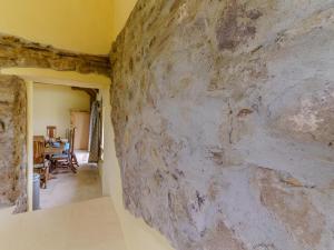 a large stone wall in a room with a table at The Stables - Uk32514 in Marloes +32 photos