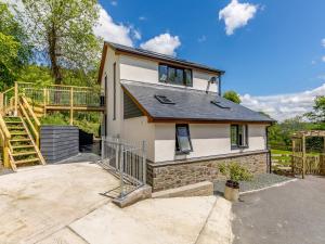 a house with a staircase in front of it at Barn Owls Rest in Clyro