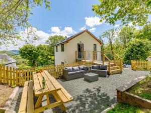 a backyard with a picnic table and a house at Barn Owls Rest in Clyro