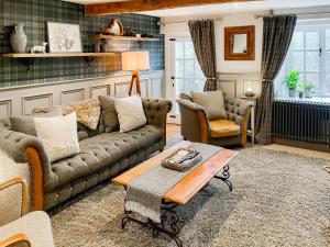 a living room with a couch and a table at Hob Cote - Cottage in Heptonstall +36 photos