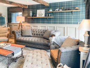 a living room with two couches and a table at Hob Cote - Cottage in Heptonstall
