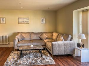 a living room with a couch and a table at Old School Mews Too in Shanklin