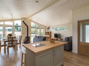 a kitchen and living room with a table and chairs at Oak Lodge in Hassocks